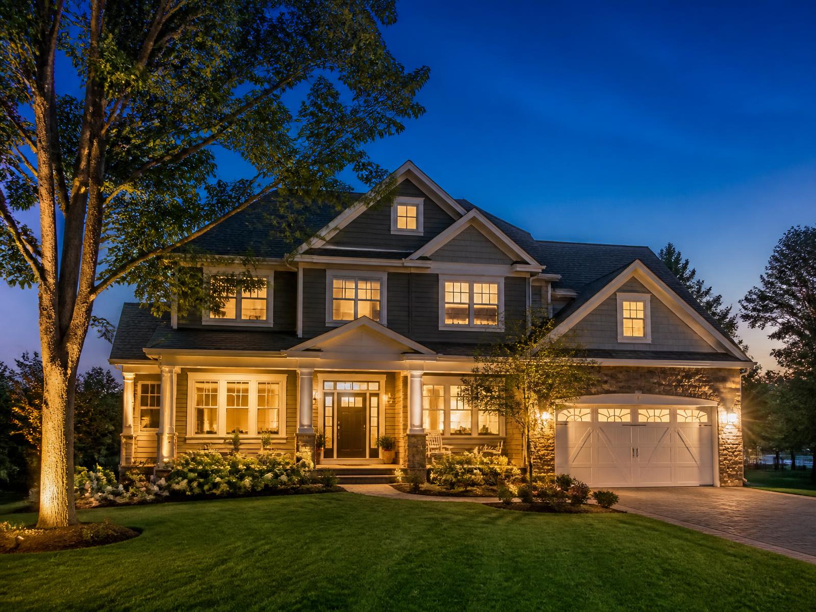 Well-kept two-story family home lit at dusk